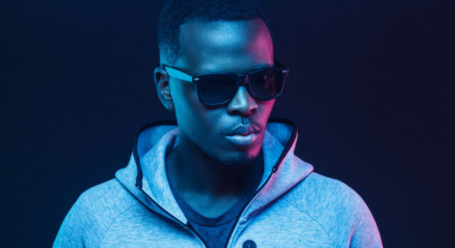 Close-up portrait of stylish black man, wearing hoodie and sunglasses