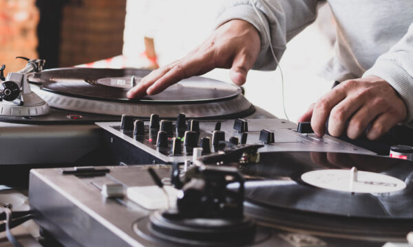DJ playing music at a hip hop party. analog turntable, Dj uses t DJ playing music at a hip hop party. analog turntable, Dj uses turntable and mixer for scratching.